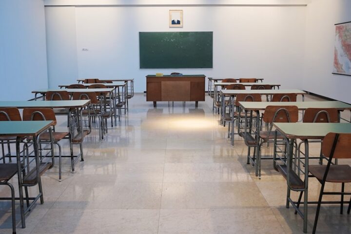 empty classroom with desks and chalkboard